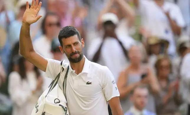 Novak Djorkovic of Serbia leaves the court after losing the men's semifinal singles match against Jannik Sinner of Italy at the Wimbledon Tennis Championships in London, Friday, July 11, 2025.(AP Photo/Kirsty Wigglesworth)