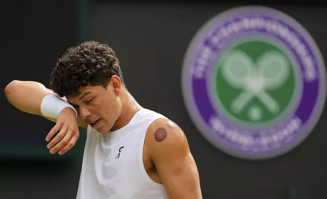 Ben Shelton of the U.S. reacts during the men's singles quarter final match against Jannik Sinner of Italy at the Wimbledon Tennis Championships in London, Wednesday, July 9, 2025.(AP Photo/Kirsty Wigglesworth)