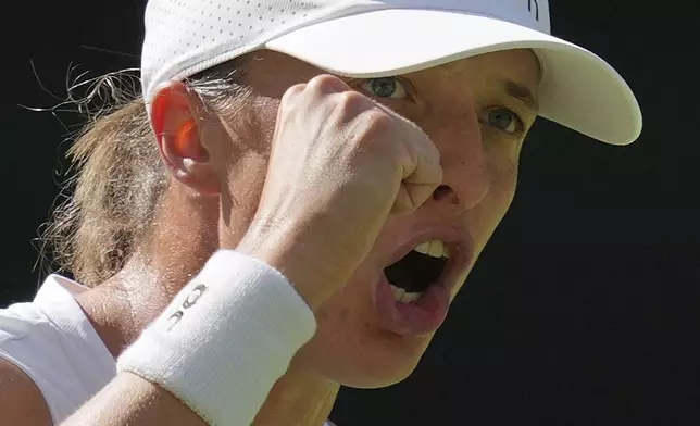 Poland's Iga Swiatek reacts as she wins a point against Switzerland's Belinda Bencic during a women's singles semifinal match at the Wimbledon Tennis Championships in London, Thursday, July 10, 2025. (AP Photo/Kin Cheung)