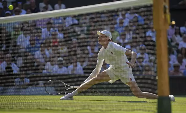 Italy's Jannik Sinner returns to Serbia's Novak Djokovic in a men's singles semifinal at the Wimbledon Tennis Championships in London, Friday, July 11, 2025. (AP Photo/Kin Cheung)