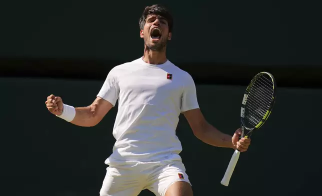 Carlos Alcaraz of Spain celebrates winning the men's semifinal singles match against Taylor Fritz of the U.S. at the Wimbledon Tennis Championships in London, Friday, July 11, 2025.(AP Photo/Kirsty Wigglesworth)