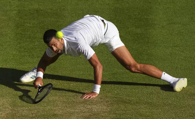 Serbia's Novak Djokovic returns to Italy's Flavio Cobolli during a quarterfinal men's singles match at the Wimbledon Tennis Championships in London, Wednesday, July 9, 2025. (AP Photo/Joanna Chan)
