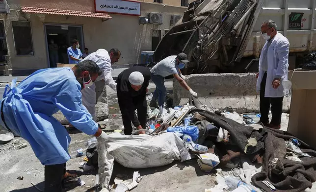 Workers clean the National Hospital following last week's sectarian clashes in the Druze-majority town of Sweida, Syria, on Friday, July 25, 2025. (AP Photo/Omar Sanadiki)