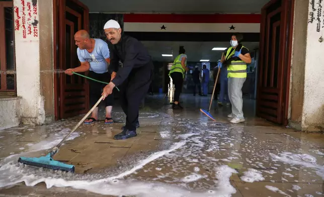 Workers clean a part of the National Hospital after last week's sectarian clashes in the Druze-majority town of Sweida, Syria, on Friday, July 25, 2025. (AP Photo/Omar Sanadiki)