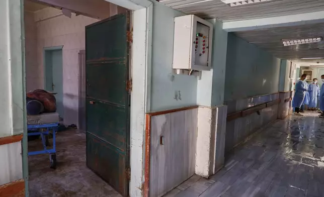 A body recovered from the streets lies on a stretcher in a corridor of the National Hospital after last week's sectarian clashes in the Druze-majority town of Sweida, Syria, on Friday, July 25, 2025. (AP Photo/Omar Sanadiki)