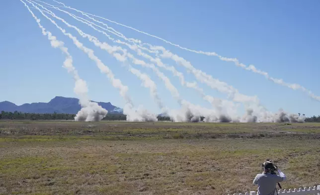 Rockets are launched from a High Mobility Artillery Rocket System during Exercise Talisman Sabre 2025, Australia's largest-ever war fighting drills at Shoalwater Bay Training Area, near Rockhampton, Australia, Monday, July 14, 2025. (AP Photo/Rick Rycroft)