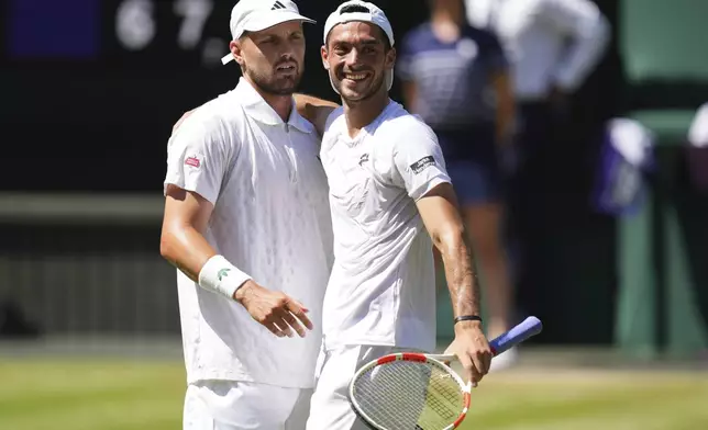 Julian Cash of Britain, right celebrates with Lloyd Glasspool of Britain after winning the men's doubles final match against Rinky Hijikata of Australia and David Pel of the Netherlands at the Wimbledon Tennis Championships in London, Saturday, July 12, 2025.(AP Photo/Kirsty Wigglesworth)
