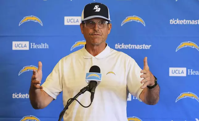 Los Angeles Chargers head coach Jim Harbaugh speaks at a news conference during an NFL football training camp Tuesday, July 22, 2025, in San Diego. (AP Photo/Gregory Bull)