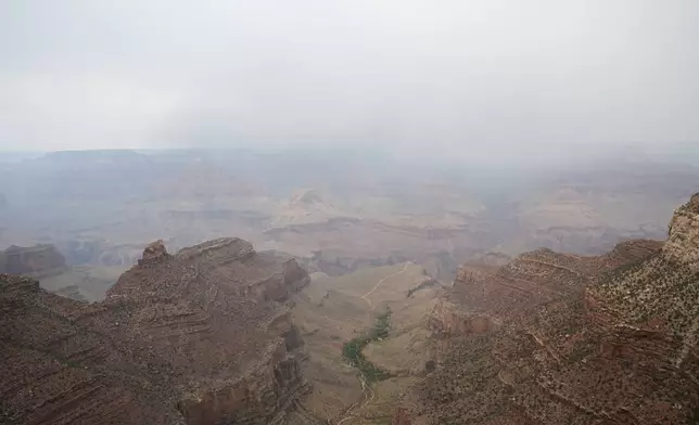 Smoke from the Dragon Bravo Fire moves over the Grand Canyon from the North Rim, Monday, July 14, 2025, in Grand Canyon National Park, Ariz. (AP Photo/Ross D. Franklin)