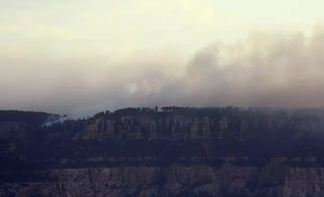 Smoke from the Dragon Bravo Fire moves across the Grand Canyon from the North Rim Tuesday, July 15, 2025, in Grand Canyon National Park, Ariz. (AP Photo/Ross D. Franklin)