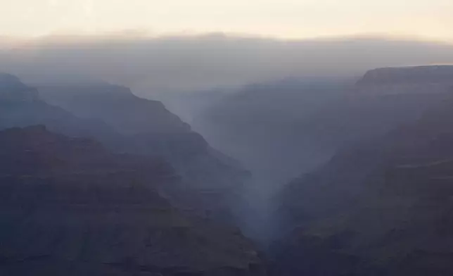 Smoke from the Dragon Bravo Fire moves over the Grand Canyon from the North Rim Tuesday, July 15, 2025, in Grand Canyon National Park, Ariz. (AP Photo/Ross D. Franklin)