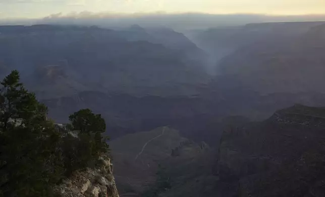 Smoke from the Dragon Bravo Fire moves over the Grand Canyon from the North Rim Tuesday, July 15, 2025, in Grand Canyon National Park, Ariz. (AP Photo/Ross D. Franklin)