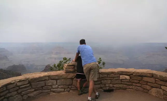 Smoke from the Dragon Bravo Fire moves over the Grand Canyon from the North Rim, Monday, July 14, 2025, in Grand Canyon National Park, Ariz. (AP Photo/Ross D. Franklin)