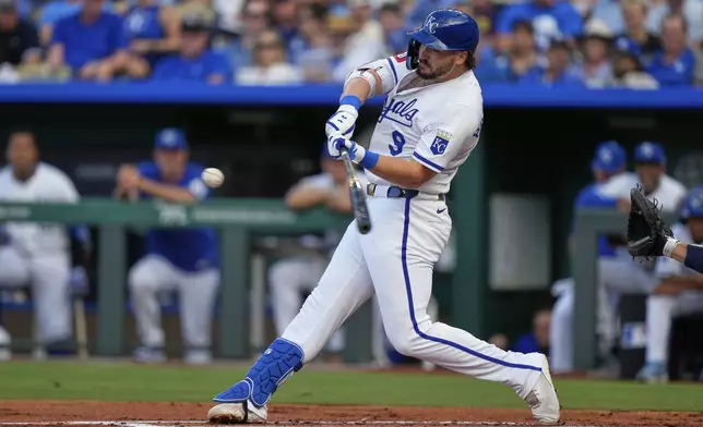 Kansas City Royals' Vinnie Pasquantino hits a solo home run during the first inning of a baseball game against the Atlanta Braves, Tuesday, July 29, 2025, in Kansas City, Mo. (AP Photo/Charlie Riedel)
