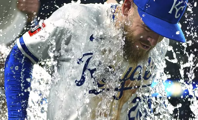 Kansas City Royals' Kyle Isbel is doused by teammates after their baseball game against the Atlanta Braves, Tuesday, July 29, 2025, in Kansas City, Mo. (AP Photo/Charlie Riedel)