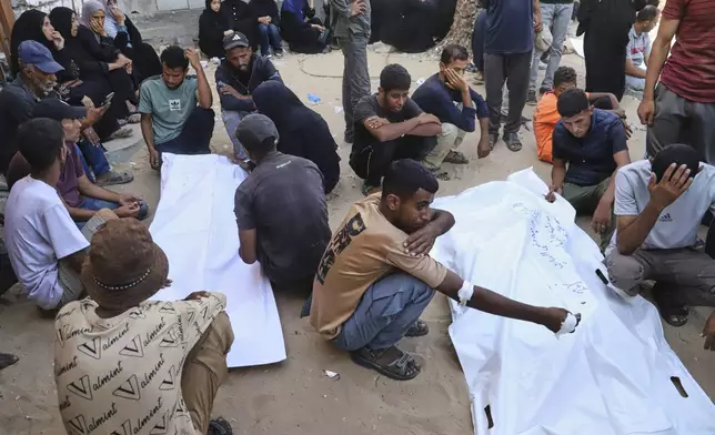 Relatives of Palestinians killed at an aid distribution center run by the Gaza Humanitarian Foundation, a U.S.-backed organization approved by Israel, mourn over their bodies during their funeral at Nasser Hospital in Khan Younis, southern Gaza Strip, Saturday, July 19, 2025. (AP Photo/Mariam Dagga)
