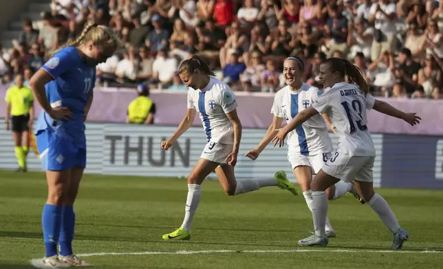 Finland 's Katariina Kosola, center, celebrates after scoring her side's first goal during the Euro 2025, group A, soccer match between Iceland and Finland at Arena Thun in Thun, Switzerland, Wednesday, July 2, 2025. (AP Photo/Alessandra Tarantino)