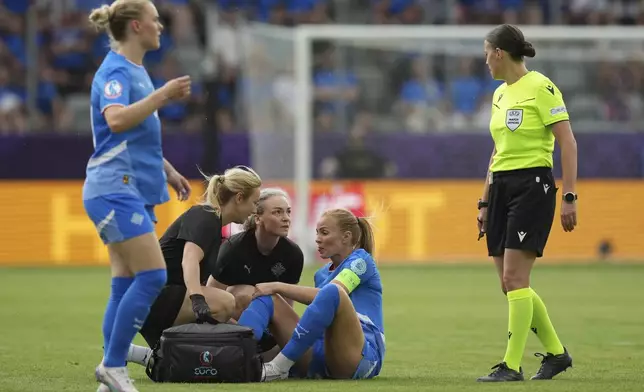 Iceland's Glodis Viggosdottir sits on the pitch after an injury during the Euro 2025, group A, soccer match between Iceland and Finland at Arena Thun in Thun, Switzerland, Wednesday, July 2, 2025.. (AP Photo/Alessandra Tarantino)