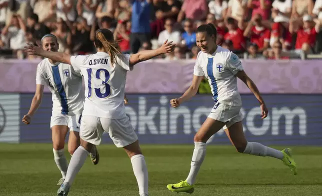 Finland 's Katariina Kosola, right, celebrates after scoring her side's first goal during the Euro 2025, group A, soccer match between Iceland and Finland at Arena Thun in Thun, Switzerland, Wednesday, July 2, 2025. (AP Photo/Alessandra Tarantino)