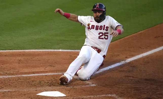 Los Angeles Angels' Travis d'Arnaud scores on a sacrifice fly by Nolan Schanuel during the third inning of a baseball game Wednesday, July 9, 2025 in Anaheim, Calif. (AP Photo/Mark J. Terrill)