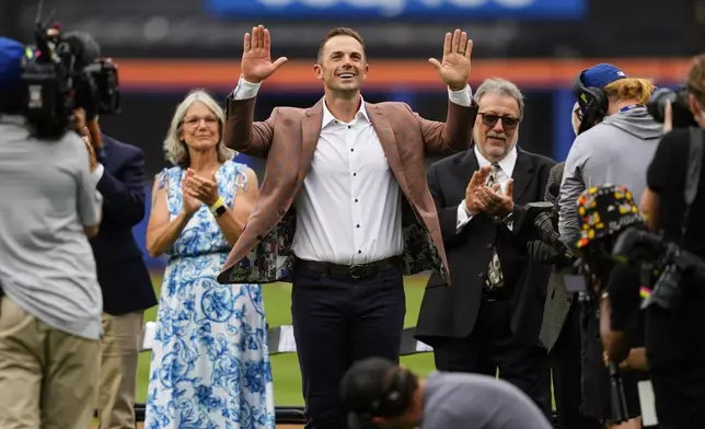 Former New York Mets third baseman David Wright, center, attends a ceremony ahead of a baseball game against the Cincinnati Reds, Saturday, July 19, 2025, in New York. (AP Photo/Yuki Iwamura)