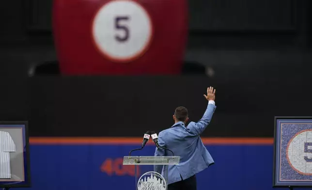 Former New York Mets third baseman David Wright waves during a ceremony ahead of a baseball game against the Cincinnati Reds, Saturday, July 19, 2025, in New York. (AP Photo/Yuki Iwamura)