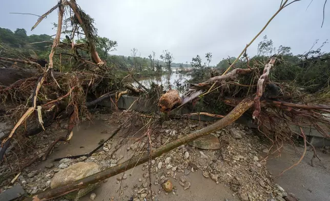 Debris sit on a bridge over the Guadalupe River after a flash flood swept through the area Saturday, July 5, 2025, in Ingram. (AP Photo/Julio Cortez)