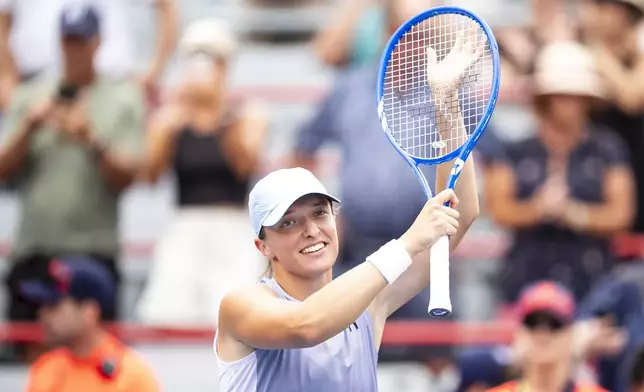 Iga Swiatek, of Poland, celebrates after defeating Guo Hanyu, of China, during second round tennis at the National Bank Open tennis tournament in Montreal on Wednesday, July 30, 2025. (Christopher Katsarov/The Canadian Press via AP)