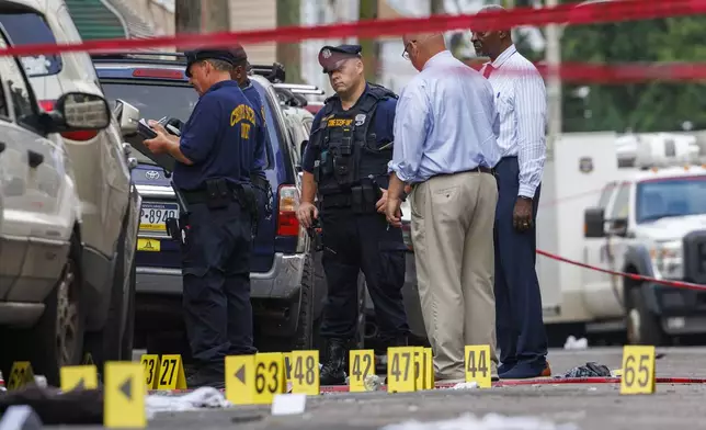 Crime Scene Unit officers and detectives work the scene of an overnight shooting in Philadelphia, early Monday, July 7, 2025. (Alejandro A. Alvarez/The Philadelphia Inquirer via AP)