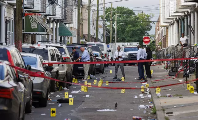 Crime scene evidence markers line a street in Philadelphia after an overnight shooting, early Monday, July 7, 2025. (Alejandro A. Alvarez/The Philadelphia Inquirer via AP)