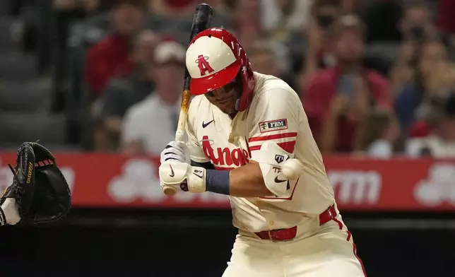 Los Angeles Angels' Mike Trout is hit by a pitch during the eighth inning of a baseball game against the Texas Rangers, Tuesday, July 29, 2025, in Anaheim, Calif. (AP Photo/Mark J. Terrill)