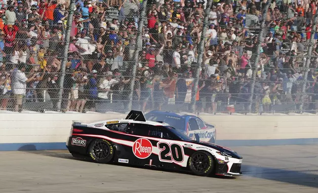Christopher Bell (20) spins ahead of Kyle Larson (5) during a NASCAR Cup Series auto race at Dover Motor Speedway, Sunday, July 20, 2025, in Dover, Del. (AP Photo/Derik Hamilton)