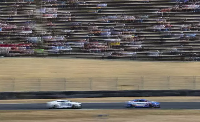 Kyle Larson (5) drives while followed by Chase Elliott (9) during a NASCAR Cup Series auto race at Sonoma Raceway, Sunday, July 13, 2025, in Sonoma, Calif. (AP Photo/Godofredo A. Vásquez)