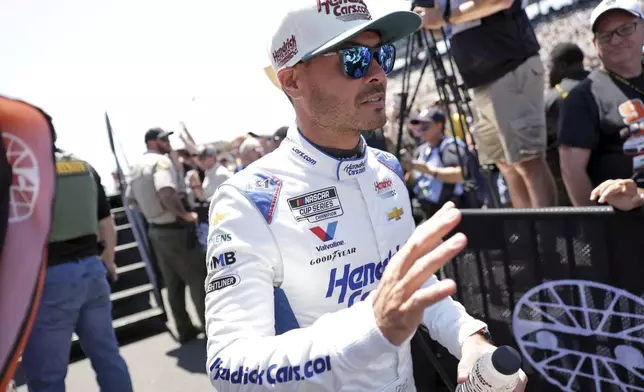 Kyle Larson waves at fans after being introduced before a NASCAR Cup Series auto race at Sonoma Raceway in Sonoma, Calif., Sunday, July 13, 2025. (Scott Strazzante/San Francisco Chronicle via AP)