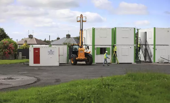 Digging equipment and workers at the site of St Mary's home for unmarried mothers, in Tuam, Ireland, July 7, 2025. (AP Photo/Peter Morrison)