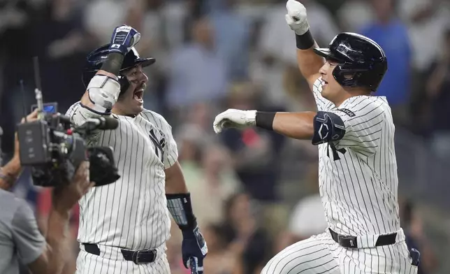 New York Yankees' Anthony Volpe, right, celebrates with Austin Wells after hitting a home run during the ninth inning of a baseball game against the Tampa Bay Rays Wednesday, July 30, 2025, in New York. (AP Photo/Frank Franklin II)