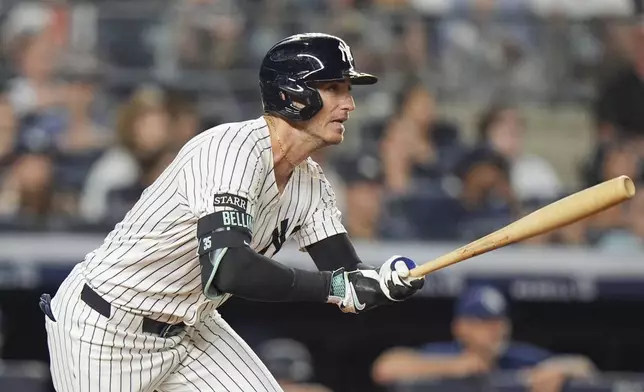 New York Yankees' Cody Bellinger follows through on an RBI triple during the 10th inning of a baseball game against the Tampa Bay Rays Wednesday, July 30, 2025, in New York. (AP Photo/Frank Franklin II)