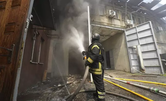 Firefighters tackle the blaze after a Russian attack that hit a residential area in Kharkiv, Ukraine, Thursday, July 24, 2025. (AP Photo/Andrii Marienko)