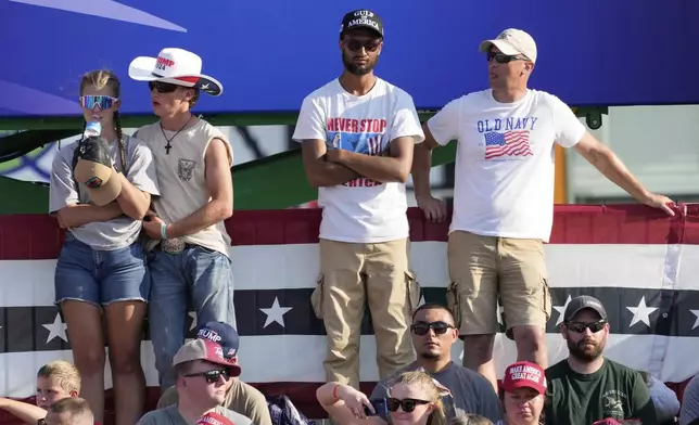 People listen before President Donald Trump arrives at a rally, Thursday, July 3, 2025, in Des Moines, Iowa. (AP Photo/Charlie Neibergall)
