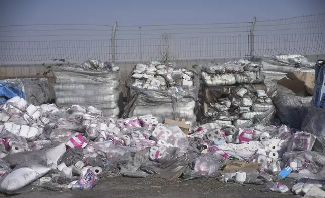 FILE - Piles of humanitarian aid packages wait to be picked up on the Palestinian side of the Kerem Shalom crossing in the Gaza Strip, Thursday, July 24, 2025, during a media tour organized by the Israeli army. (AP Photo/Ohad Zwigenberg, file)