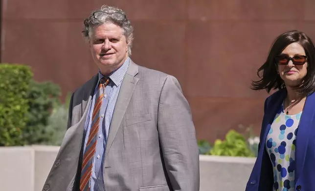 Attorney Jerome Friedberg, left, walks out of the Edward R. Roybal Federal Building after obtaining bail for his client, former NBA star Gilbert Arenas in Los Angeles, on Wednesday, July 30, 2025. (AP Photo/Damian Dovarganes)