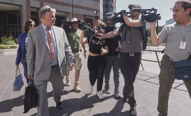 Attorney Jerome Friedberg, left, talks to the media as he walks out of the Edward R. Roybal Federal Building in Los Angeles, on Wednesday, July 30, 2025. (AP Photo/Damian Dovarganes)