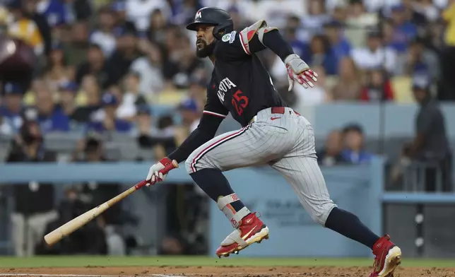 Minnesota Twins' Byron Buxton watches his single during the second inning of a baseball game against the Los Angeles Dodgers Tuesday, July 22, 2025, in Los Angeles. (AP Photo/Eric Thayer)
