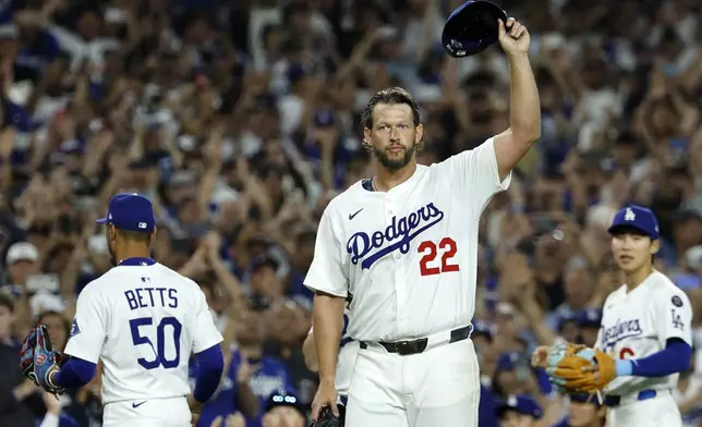 Los Angeles Dodgers pitcher Clayton Kershaw (22) tips his cap after recording his 3,000th career strike out by striking out Chicago White Sox's Vinny Capra during the sixth inning of a baseball game Wednesday, July 2, 2025, in Los Angeles. (AP Photo/Kevork Djansezian)