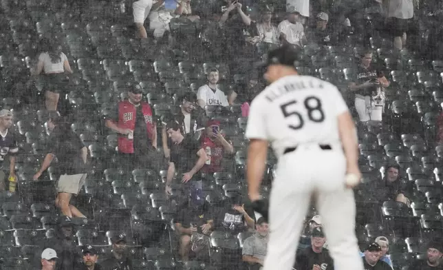Baseball fans watch during the seventh inning of a baseball game between the Toronto Blue Jays and the Chicago White Sox in Chicago, Tuesday, July 8, 2025. (AP Photo/Nam Y. Huh)