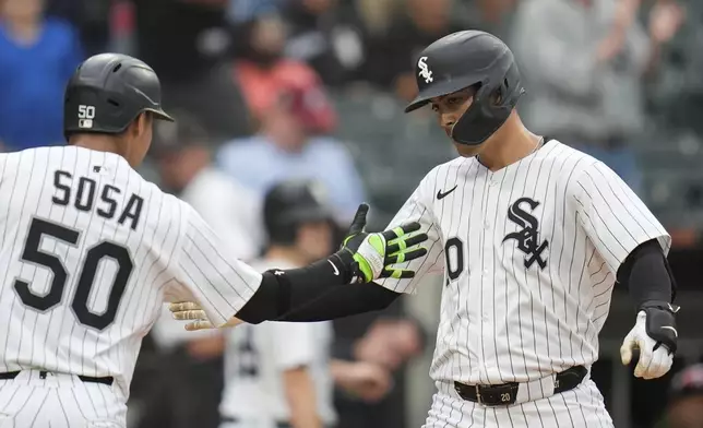 CORRECTS INNING - Chicago White Sox's Miguel Vargas (20), right, and Lenyn Sosa (50) celebrate Vargas' three-run home run during the seventh inning of a baseball game against the Philadelphia Phillies, Wednesday, July 30, 2025, in Chicago. (AP Photo/Erin Hooley)