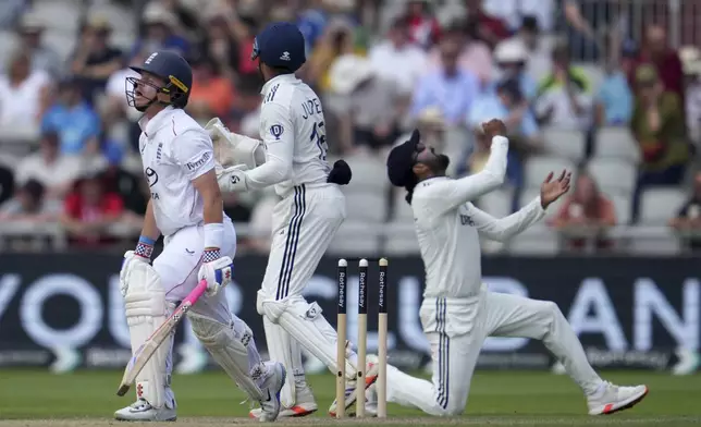 India's KL Rahul, right, and Dhruv Jurel, center, celebrates the dismissal of England's Ollie Pope, left, on the third day of the fourth cricket test match between England and India at Emirates Old Trafford, Manchester, England, Friday, July 25, 2025. (AP Photo/Jon Super)