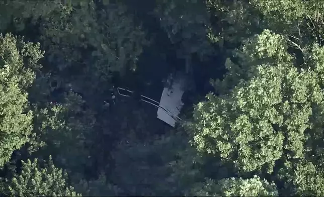 This image taken from video provided by WPVI-TV/6ABC shows a small skydiving aircraft that went off the end of a runway at Cross Keys Airport in Gloucester County, N.J., on Wednesday evening, July 2, 2025. (WPVI-TV/6ABC via AP)