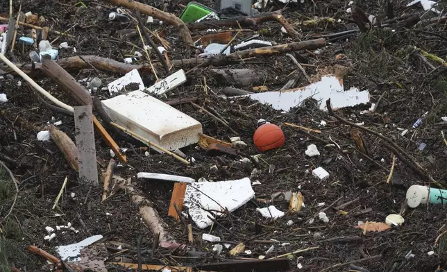 Debris is left behind by a raging Guadalupe River, Friday, July 4, 2025, in Kerrville, Texas. (AP Photo/Eric Gay)
