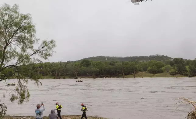 A Texas DPS helicopter conducts arial searches along the Guadalupe River in the wake of a destructive flooding event in Kerrville on Friday July 4, 2025. (Christopher Lee/The San Antonio Express-News via AP)